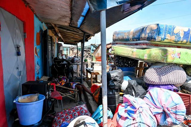 Residents gather their belongings to leave before the destruction of the precarious Zimbabwe neighbourhood during an eviction operation in the Port-Bouet neighbourhood in Abidjan on June 3, 2026. (Photo by Sia KAMBOU / AFP)