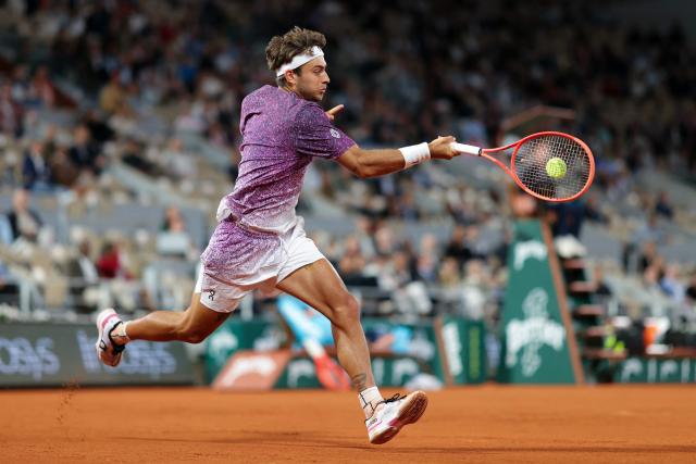 Italy's Flavio Cobolli plays a forehand return to Canada's Felix Auger-Aliassime during their men's quarter final singles match on day 11 of the French Open tennis tournament on Court Philippe-Chatrier at the Roland-Garros Complex in Paris on June 3, 2026. (Photo by Thomas SAMSON / AFP)