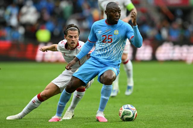 Denmark's midfielder #07 Mathias Jensen (L) fights for the ball with Congo's midfielder #25 Edo Kayembe during the international friendly football match between Denmark and DR Congo ahead of the 2026 FIFA World Cup football tournament at the Stade Maurice Dufrasne in Liege on June 3, 2026. (Photo by NICOLAS TUCAT / AFP)
