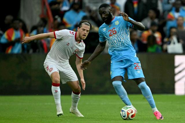 Denmark's midfielder #07 Mathias Jensen (L) fights for the ball with Congo's defender #26 Arthur Masuaku during the international friendly football match between Denmark and DR Congo ahead of the 2026 FIFA World Cup football tournament at the Stade Maurice Dufrasne in Liege on June 3, 2026. (Photo by NICOLAS TUCAT / AFP)