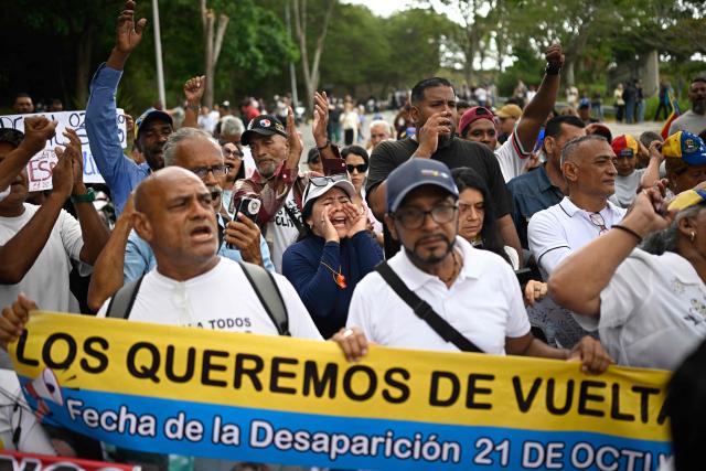 Wrkers and pensioners shout slogans as they takey part in a march demanding better working conditions and a political transition, outside the US embassy in Caracas on June 3, 2026. (Photo by Federico PARRA / AFP)