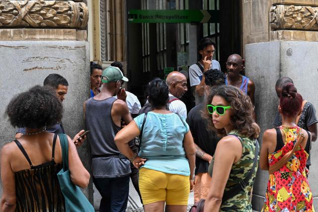 People queue outside a bank in Havana on June 3, 2026. Visa and Mastercard payments in Cuba will be suspended from June 7, 2026, after US sanctions prompted a foreign bank to sever ties with a financial institution, Cuba's central bank said on June 3. (Photo by YAMIL LAGE / AFP)