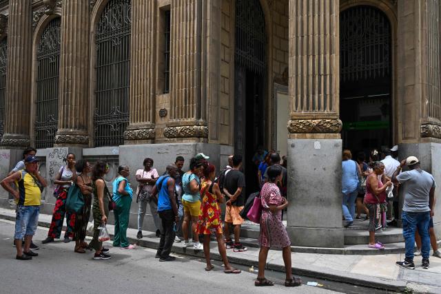 People queue outside a bank in Havana on June 3, 2026. Visa and Mastercard payments in Cuba will be suspended from June 7, 2026, after US sanctions prompted a foreign bank to sever ties with a financial institution, Cuba's central bank said on June 3. (Photo by YAMIL LAGE / AFP)