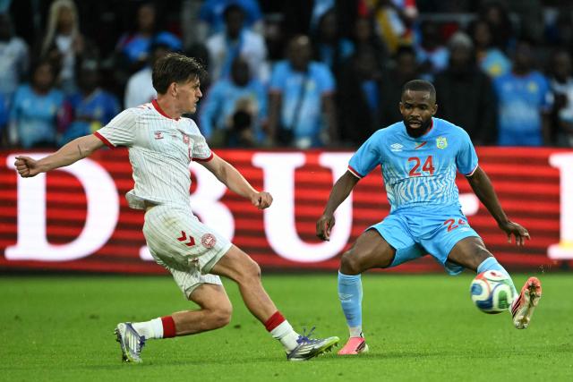 Denmark's defender #05 Joakim Maehle (L) fights for the ball with Congo's defender #24 Gedeon Kalulu during the international friendly football match between Denmark and DR Congo ahead of the 2026 FIFA World Cup football tournament at the Stade Maurice Dufrasne in Liege on June 3, 2026. (Photo by NICOLAS TUCAT / AFP)