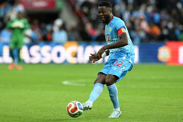 Congo's defender #22 Chancel Mbemba shoots the ball during the international friendly football match between Denmark and DR Congo ahead of the 2026 FIFA World Cup football tournament at the Stade Maurice Dufrasne in Liege on June 3, 2026. (Photo by NICOLAS TUCAT / AFP)