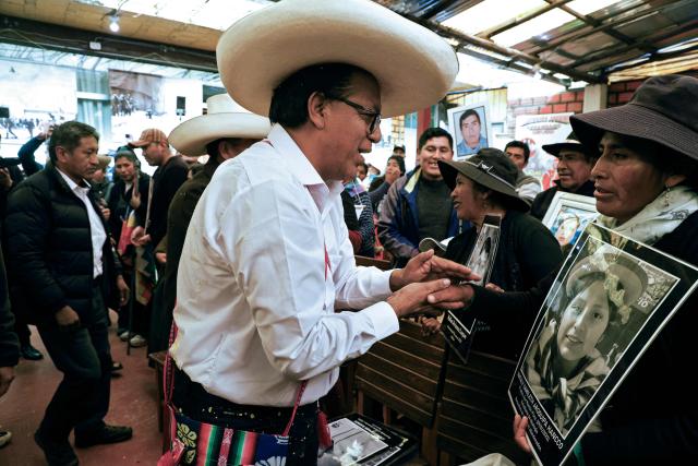 Peru's presidential candidate for the Juntos por el Peru party, Roberto Sanchez, greets members of the association of relatives of victims of the 2022-2023 protests against President Dina Boluarte, in Juliaca, Peru, on June 03, 2026. Peruvians will choose their president on June 7, 2026, between right-wing candidate Keiko Fujimori, heir to a political dynasty that divides the nation, and left-wing candidate Roberto Sáncheztwo diametrically opposed visions for a country plagued by instability and crime. (Photo by Juan Carlos CISNEROS / AFP)