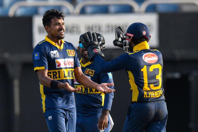 Sri Lanka bowler Maheesh Theekshana (L) celebrates with the wicketkeeper and captain Kusal Mendis after taking the wicket of West Indies batsman Gudakesh Motie for 22 runs during the first One Day International (ODI) cricket match between West Indies and Sri Lanka at Sabina Park in Kingston, Jamaica, on June 3, 2026. (Photo by Randy Brooks / AFP)