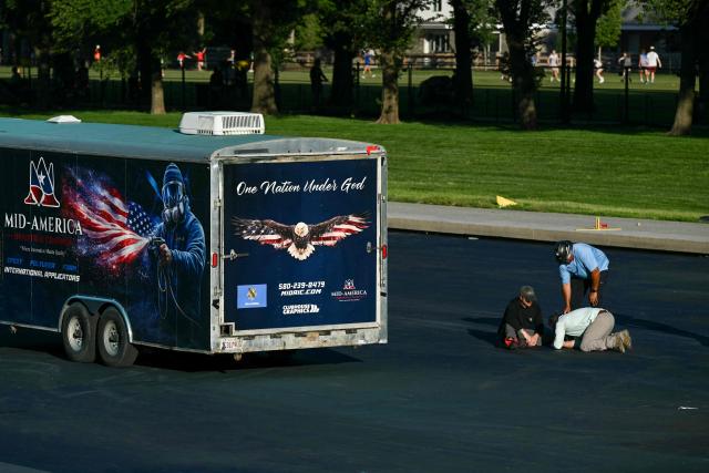 Contractors work on the Reflecting Pool at the National Mall in Washington, DC, on June 3, 2026. (Photo by Brendan SMIALOWSKI / AFP)