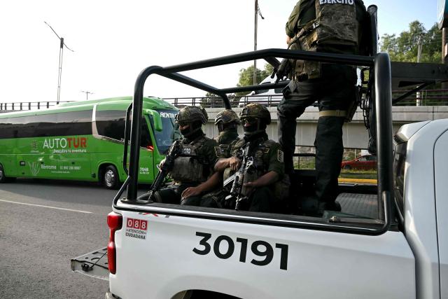 Mexican soldiers escort the bus carrying the players of South Africa after a training session in Pachuca, Mexico on June 3, 2026, ahead of the FIFA 2026 World Cup football tournament. (Photo by Yuri CORTEZ / AFP)
