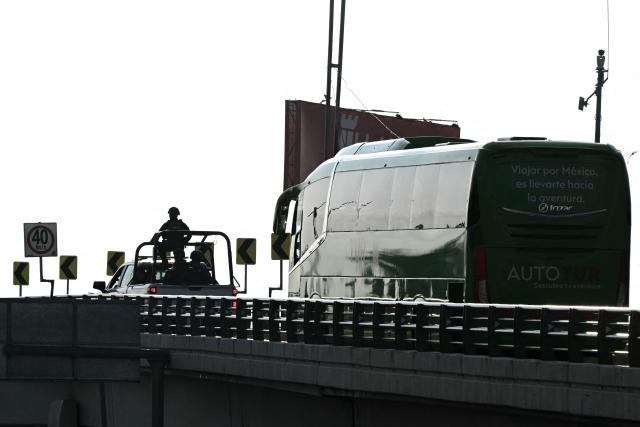 Mexican soldiers escort the bus carrying the players of South Africa after a training session in Pachuca, Mexico on June 3, 2026, ahead of the FIFA 2026 World Cup football tournament. (Photo by YURI CORTEZ / AFP)