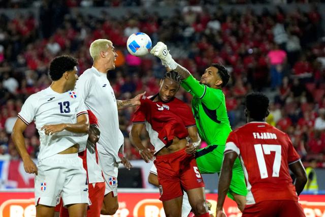 Panama's goalkeeper #12 Cesar Samudio (C-R) clears the ball past Dominican Republic's defender #05 Noah Dollenmayer (C-L) during the international friendly football match between Panama and Dominican Republic at the Rommel Fernandez Gutierrez Stadium in Panama City on June 3, 2026. (Photo by ARNULFO FRANCO / AFP)