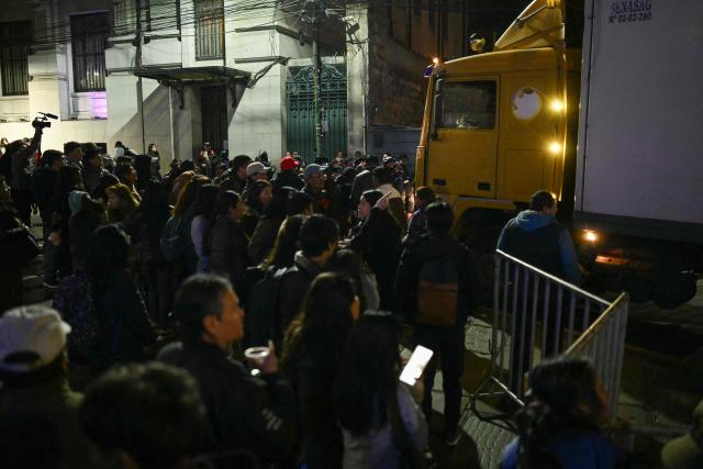 People block a truck during a protest over a lack of chickens amid food shortages caused by the blockades, in La Paz on June 3, 2026. Hundreds of demonstrators demanded on June 1, in Bolivia’s political capital the resignation of President Rodrigo Paz, as one month of protests and road blockades continues across the country with no solution to the crisis in sight. (Photo by Marvin RECINOS / AFP)
