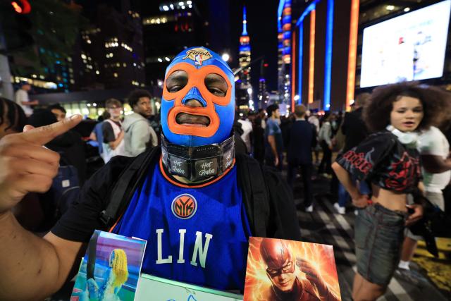 A New York Knicks fan, wearing a wrestling mask, poses for a photo outside Madison Square Garden during Game 1 of the NBA Finals between the New York Knicks and the San Antonio Spurs, in New York City, on June 3, 2026. (Photo by TIMOTHY A.CLARY / AFP)