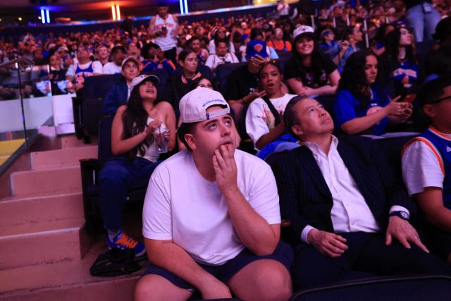 Fans react as they watch Game 1 of the NBA Finals between the New York Knicks and the San Antonio Spurs on a screen at Madison Square Garden in New York City on June 3, 2026. (Photo by Timothy A. CLARY / AFP)