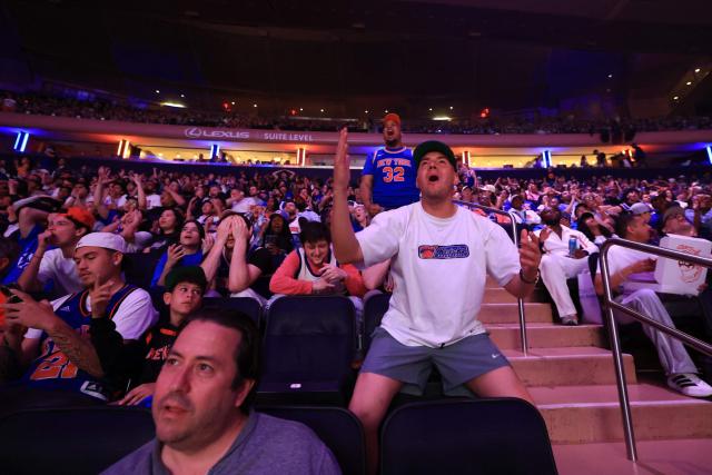 Fans react as they watch Game 1 of the NBA Finals between the New York Knicks and the San Antonio Spurs on a screen at Madison Square Garden in New York City on June 3, 2026. (Photo by Timothy A. CLARY / AFP)