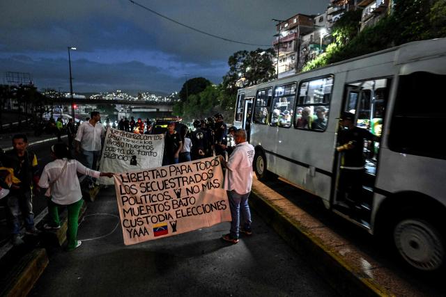 Relatives of political prisoners take part in a demonstration to demand their freedom during a prisoners' transfer outside El Helicoide prison in Caracas on June 3, 2026. (Photo by Juan BARRETO / AFP)