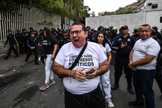 A relative of political prisoners takes part in a demonstration to demand their freedom during a prisoners transfer outside El Helicoide prison in Caracas on June 3, 2026. (Photo by Juan BARRETO / AFP)