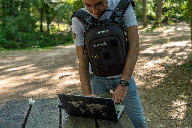 This photograph taken on May 21, 2026 in the Monteguait massif near Aix-en-Provence shows a member of the Fire Chaser association watching the Fire Chaser application on his computer. Founded in 2018 and recognised as being of public interest in 2025, Fire Chaser is a volunteer-run wildfire prevention association operating in the Bouches-du-Rhone department that developed a free mobile app allowing users to report and track fires in real time. (Photo by MIGUEL MEDINA / AFP)