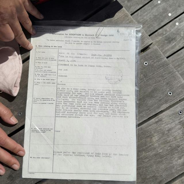 A picture shows the adoptions papers of adopted Sofie Randel on May 9, 2026 in Kastrup near Copenhagen, Denmark. Eight South Korean adoptees are suing Denmark for its role in their illegal adoptions, demanding the state admit responsibility for violating their right to their identity, origins and family. (Photo by Camille BAS-WOHLERT / AFP)