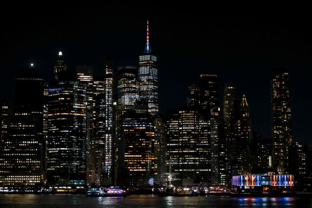 Manhattan buildings lit up in orange and blue seen during Game 1 of the NBA Finals between the New York Knicks and the San Antonio Spurs in New York, on June 03, 2026. (Photo by ANGELA WEISS / AFP)