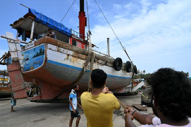 Fishermen moor a boat at Madh Island in Mumbai on June 3, 2026 following the annual 61-day fishing ban along India's coastal region to protect marine life during the monsoon breeding season. (Photo by Indranil Mukherjee / AFP)