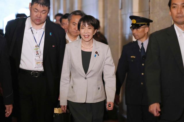 Japan's Prime Minister Sanae Takaichi (C) arrives at the National Diet to attend a House of Representatives budget committee session in Tokyo on June 4, 2026. (Photo by Kazuhiro NOGI / AFP)