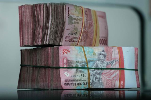 Bundles of Indonesian rupiah banknotes are pictured at a currency exchange office in Jakarta on June 4, 2026, after the rupiah weakened beyond 18,000 per US dollar for the first time. (Photo by Yasuyoshi Chiba / AFP)