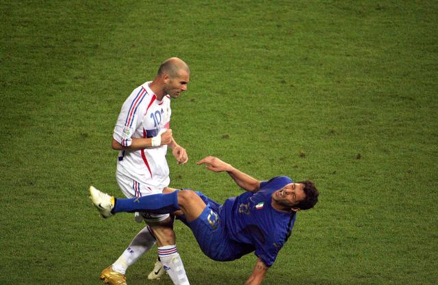 (FILES) A photo taken 09 July 2006 of French midfielder Zinedine Zidane (L) gesturing after head butting Italian defender Marco Materazzi during the World Cup 2006 final football match between Italy and France at Berlin’s Olympic Stadium.  AFP PHOTO / JOHN MACDOUGALL. From the artistry of Pele to Maradona's "Hand of God", Zidane's headbutt and the clash between France's Battiston against Germany's Schumacher... Heroic, historic, dramatic, bizarre, spectacular, jubilant—the glorious history of the World Cup is full of unforgettable moments. (Photo by John MACDOUGALL / AFP)