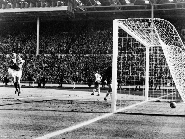 (FILES) England's forward Geoff Hurst (2nd L) is being congratulated by his teammate midfielder Alan Ball after scoring his second overtime goal, and his third of the match, as England defeated West Germany 4-2 in extra-time in the World Cup final on July 30, 1966 at Wembley stadium in London. From the artistry of Pele to Maradona's "Hand of God", Zidane's headbutt and the clash between France's Battiston against Germany's Schumacher... Heroic, historic, dramatic, bizarre, spectacular, jubilantthe glorious history of the World Cup is full of unforgettable moments. (Photo by AFP)