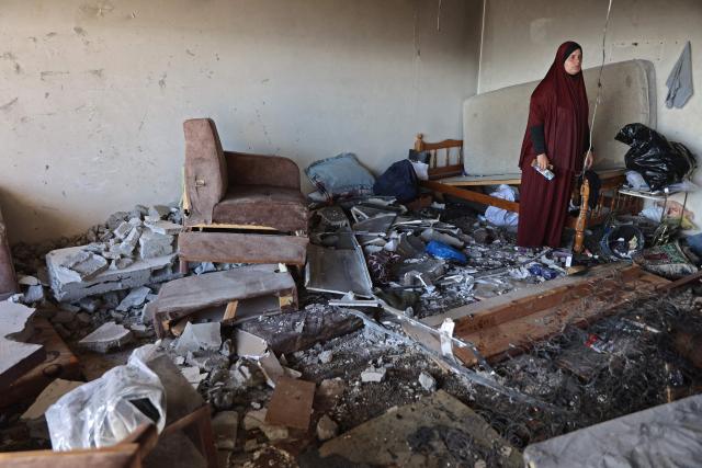 A Palestinian woman stands amid the debris of a damaged residential building after an Israeli strike in Gaza City on June 4, 2026. Israeli attacks on Gaza killed at least eight people on June 4, a spokesman for the civil defence agency in the Palestinian territory told AFP. Despite a truce technically in effect since October, daily violence has rocked the Gaza Strip, over half of which is under Israeli military control in defiance of the ceasefire's terms. (Photo by Omar AL-QATTAA / AFP)
