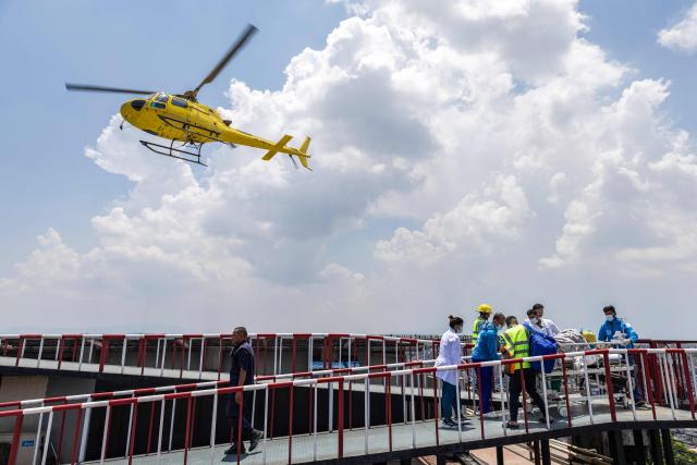 Medics and rescuers carry mountaineer Dawa Sherpa upon his arrival at the HAMS Hospital in Kathmandu on June 4, 2026. A Nepali climbing guide who went missing on Mount Everest for six days and was believed dead has been found alive after crawling alone almost to Base Camp, officials told AFP on June 4. (Photo by PRABIN RANABHAT / AFP)