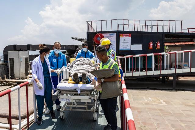 Medics and rescuers carry mountaineer Dawa Sherpa upon his arrival at the HAMS Hospital in Kathmandu on June 4, 2026. A Nepali climbing guide who went missing on Mount Everest for six days and was believed dead has been found alive after crawling alone almost to Base Camp, officials told AFP on June 4. (Photo by PRABIN RANABHAT / AFP)