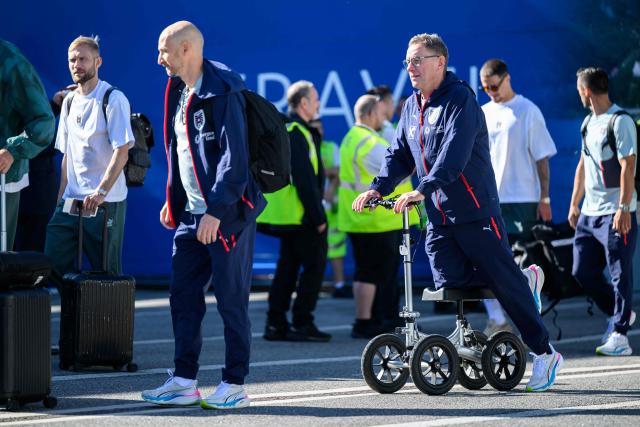 Austria's national football team coach Ralf Rangnick (R) arrives to board a plane before the team departed from the Schwechat airport near Vienna, Austria, on June 4, 2026, ahead of the FIFA 2026 World Cup. (Photo by MAX SLOVENCIK / APA / AFP) / Austria OUT