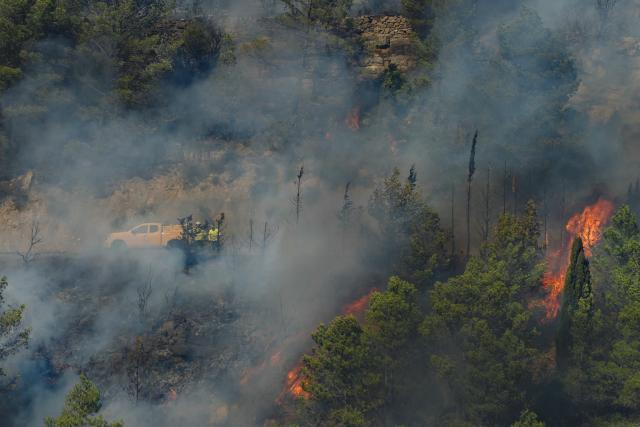 (FILES) In this photo taken on August 5, 2025, a DFCI wildfire defence vehicle from the National Forestry Office (ONF) is seen after the start of the Corbieres wildfire in Ribaute, southwest France. An agent of the National Forestry Office (ONF) is to appear on June 4, 2026, for an initial appearance hearing before investigating judges in Montpellier as part of the investigation into the causes of the Ribaute fire, which burned across 17,000 hectares in the Corbieres mountains in August 2025, the public prosecutor's office announced. (Photo by Idriss Bigou-Gilles / AFP)