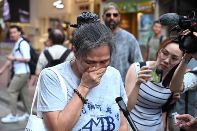 Former activist Lui Yuk-lin (C) pays her respects near Victoria Park in the Causeway Bay district of Hong Kong on June 4, 2026, where people gathered annually on June 4 to mourn the victims of China's Tiananmen Square crackdown in 1989, a tradition now banned following a national security law imposed on the city in 2020. (Photo by Peter PARKS / AFP)