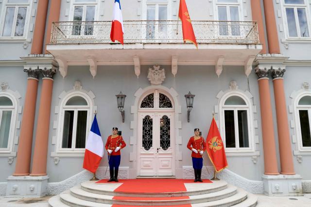 Soldiers stand guard at the front door of the Blue Palace prior to a welcome ceremony for France's President as part of his first official visit to Montenegro ahead of the EU-Western Balkans Summit, in Cetinje on June 4, 2026. (Photo by Ludovic MARIN / AFP)