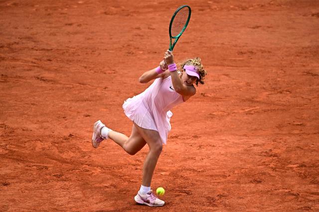 Mirra Andreeva plays a backhand return to Ukraine's Marta Kostyuk during their women's semi final singles match on day 12 of the French Open tennis tournament on Court Philippe-Chatrier at the Roland-Garros Complex in Paris on June 4, 2026. (Photo by JULIEN DE ROSA / AFP)