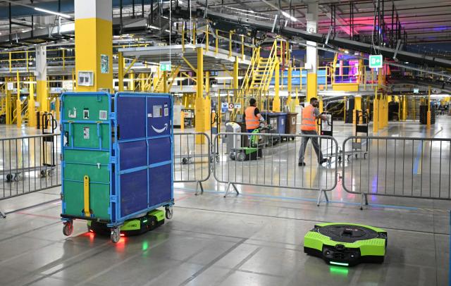 Amazon's next-generation Proteus robot are pictured working, during the second day of 'Delivering the Future EMEA ‘26', at Amazon’s LCY3 Fulfillment Centre in Dartford, east of London, on June 4, 2026. (Photo by JUSTIN TALLIS / AFP)