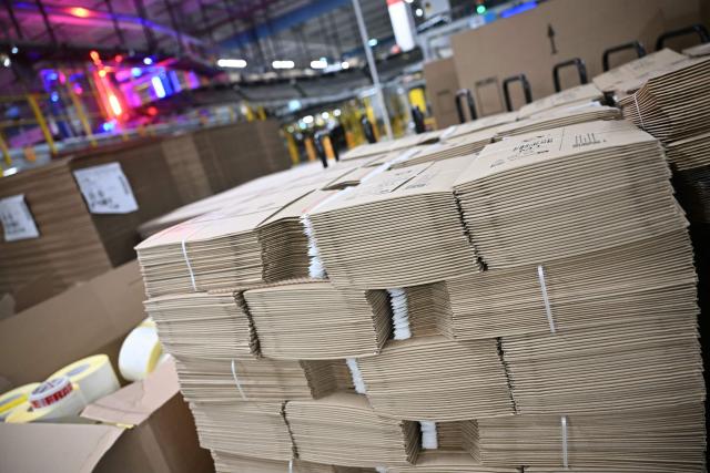 Flat-packed Amazon-branded cardboard boxes are pictured inside Amazon's LCY3 Fulfillment Centre in Dartford, east of London, on June 4, 2026, on the second day of company's 'Delivering the Future EMEA ‘26' event. (Photo by JUSTIN TALLIS / AFP)