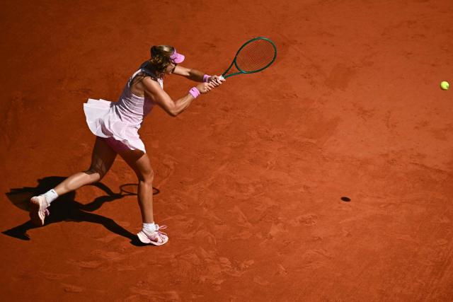 Mirra Andreeva plays a backhand return to Ukraine's Marta Kostyuk during their women's semi final singles match on day 12 of the French Open tennis tournament on Court Philippe-Chatrier at the Roland-Garros Complex in Paris on June 4, 2026. (Photo by JULIEN DE ROSA / AFP)