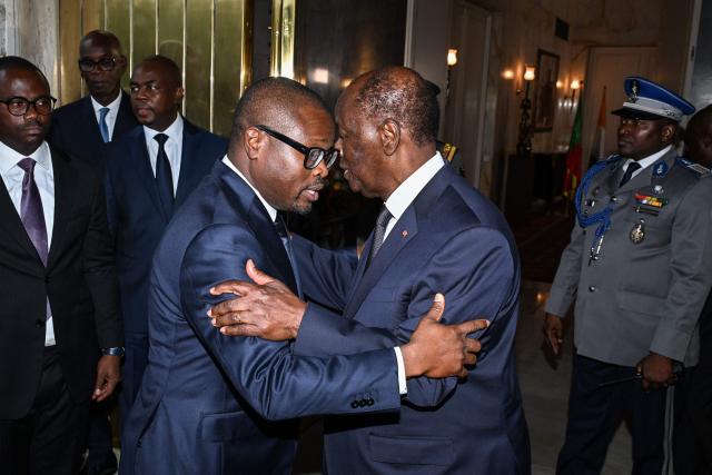 Ivory Coast's president Alassane Ouattara (R) hugs the newly elected president of Benin Romuald Wadagni (C-L) after their meeting at the presidential palace in Abidjan on June 4, 2026. (Photo by Issouf SANOGO / AFP)