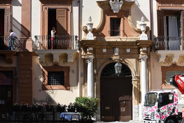 Workers clean window shutters as preparations are underway for the wedding celebrations of British singer Dua Lipa and British actor Callum Turner in Bagheria, near Palermo, Sicily, on June 4, 2026. The couple, who married in a civil ceremony in London on May 31, are set to celebrate with guests from June 5 to 7 across several Palermo venues, with the main event to be held at Villa Valguarnera in nearby Bagheria. (Photo by ALESSANDRO FUCARINI / AFP)