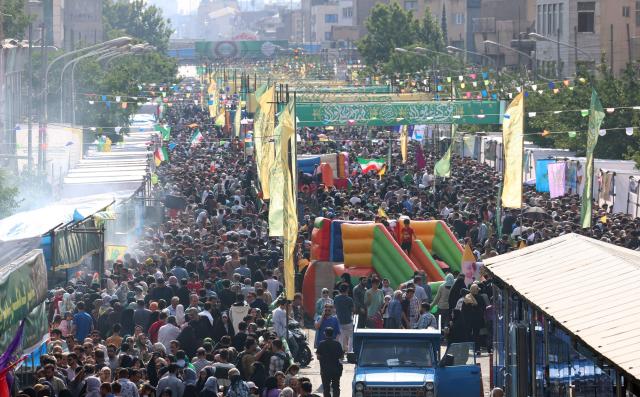 Iranians take part during a rally in support of the country's supreme leader Mojtaba Khamenei and commemorate Eid al-Ghadir in Tehran on June 4, 2026. Eid al-Ghadir commemorates the events of Ghadir al-Khumm during which Shiites believe that the Prophet Mohammed appointed Ali ibn Abi Talib, his cousin and son-in-law who was among the first Muslims, as his successor. (Photo by AFP) / 
