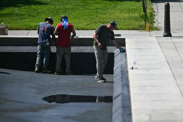 Contractors continue work on the Reflecting Pool on the National Mall in Washington, DC, on June 4, 2026. US President Donald Trump has ordered the long basin, designed to capture reflections of the towering Washington obelisk on the Mall, to be drained and painted in what he calls "American flag blue." It is expected to reopen before the July 4 holiday, which will also mark the 250th anniversary of US independence. (Photo by Kent NISHIMURA / AFP)