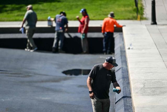 Contractors continue work on the Reflecting Pool on the National Mall in Washington, DC, on June 4, 2026. US President Donald Trump has ordered the long basin, designed to capture reflections of the towering Washington obelisk on the Mall, to be drained and painted in what he calls "American flag blue." It is expected to reopen before the July 4 holiday, which will also mark the 250th anniversary of US independence. (Photo by Kent NISHIMURA / AFP)