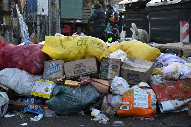 Accumulated garbage is seen in a street in La Paz on June 4, 2026, amid growing political tensions and supply shortages affecting different regions of the country. The accumulation of waste in the city reached critical levels between late May and early June, posing a serious public health and environmental risk. The disruption of garbage collection services has been attributed to road blockades and, mainly, to a shortage of diesel fuel for collection trucks. (Photo by Aizar RALDES / AFP)