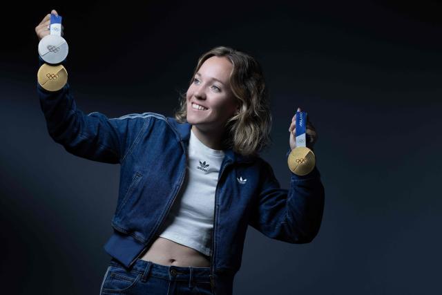 French biathlete Oceane Michelon, poses with the three medals, she won at the Milan Winter Olympic (gold for the 12.5 km mass start and the 4x6km relay and silver for the 7.5km sprint) during a photo session in Paris on June 4, 2026. (Photo by Joel Saget / AFP)