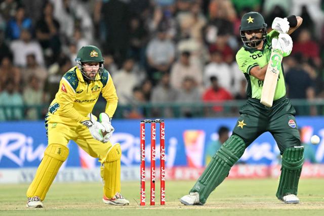Pakistan's Babar Azam (R) plays a shot during the third one-day international (ODI) cricket match between Pakistan and Australia at Gaddafi Stadium in Lahore on June 4, 2026. (Photo by Arif ALI / AFP)