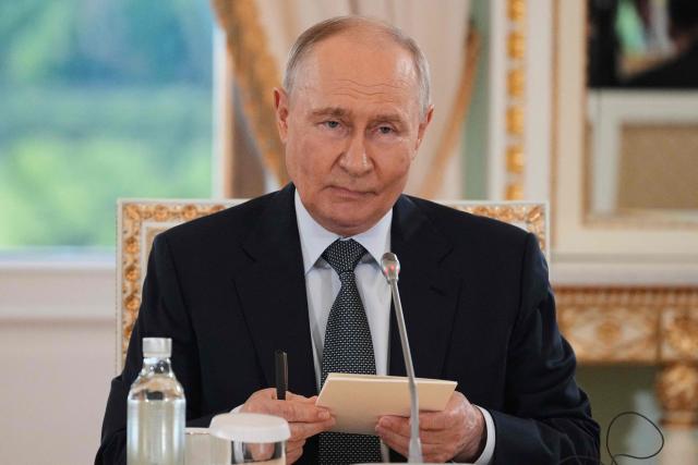 Russian President Vladimir Putin meets with representatives of international news agencies on the sidelines of the St. Petersburg International Economic Forum at the Constantine Palace in Saint Petersburg on June 4, 2026. (Photo by Dmitry LOVETSKY / POOL / AFP)