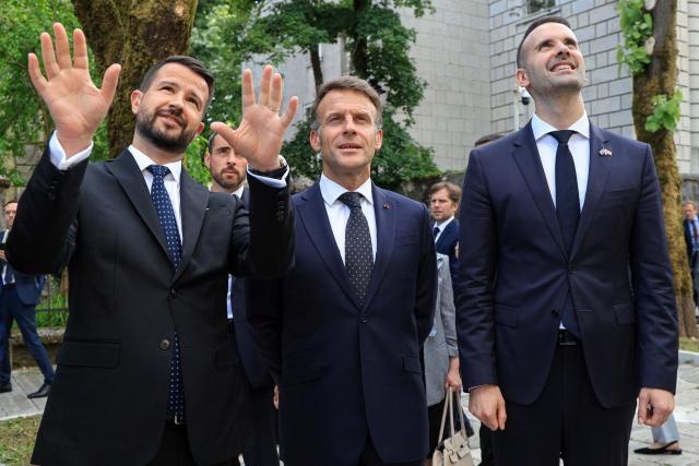 France's President Emmanuel Macron (C) listens to Montenegro's President Jakov Milatovic (L) flanked by Montenegro's Prime Minister Milojko Spajic (R) during his first official visit to Montenegro ahead of the EU-Western Balkans Summit in Cetinje on June 4, 2026. (Photo by Ludovic MARIN / AFP)